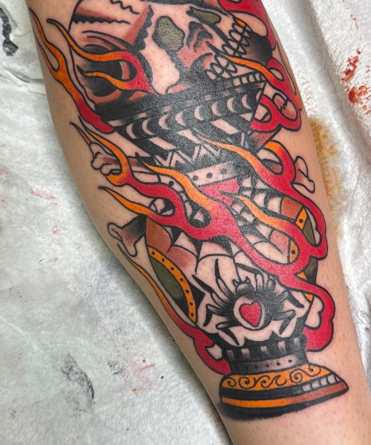 Flaming skull tattoo on a calf
