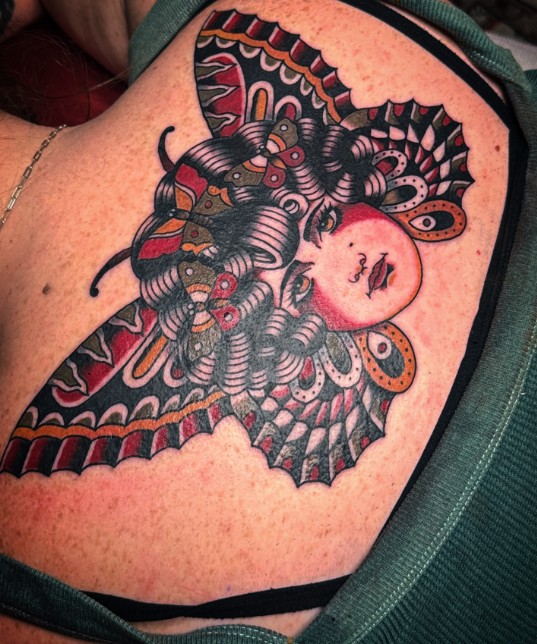 Death moth lady tattoo on a shoulder